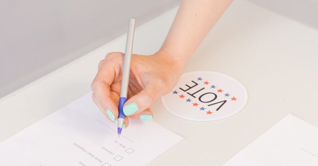 Hand filling out a voting ballot paper during an election process.
